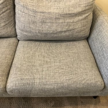 2-seater grey sofa cleaned by professional upholstery cleaner