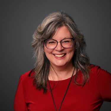 a woman with glasses and a red shirt
