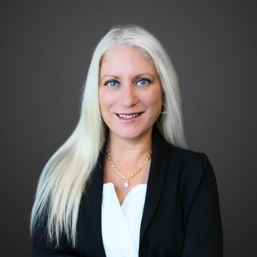 a woman with white hair and a black blazer
