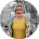 A smiling woman in a yellow top and glasses posing for a profile portrait.