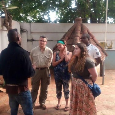 Dahomey African Tours Guide leading tourists in Pythons Temple in Benin