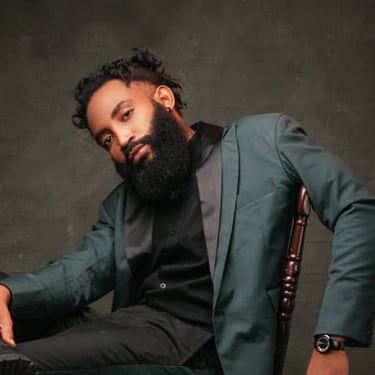 A man wearing a suit while seated on a chair