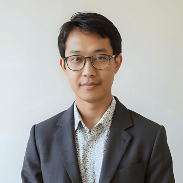 A portrait of a man with glasses wearing a suit