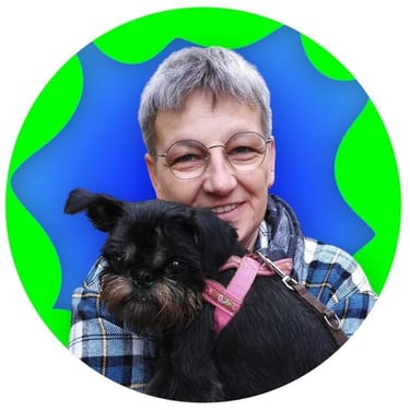 a woman in glasses and a plaid shirt is holding a dog