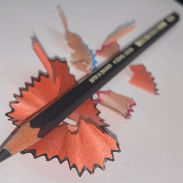 a pencil and pencil sharpener on a piece of paper