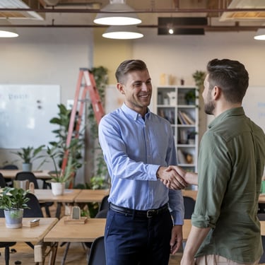  John D. small business owner smiling with consultant in Albany coworking office