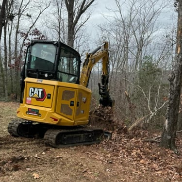 CAT excavator digging up dirt