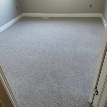 Melford low pile grey carpet installed wall-to-wall in second bedroom of London Ontario home, soft and affordable flooring