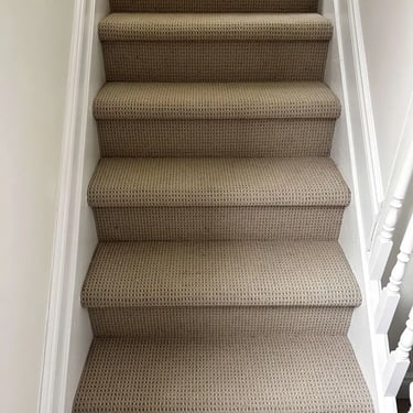 Beige textured Berber carpet installed on stairs – a cozy and practical upgrade for London homes.