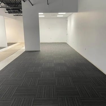 Dark grey Stave commercial carpet tile installed wall-to-wall in office hallway in London Ontario, durable and stylish