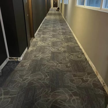 Revive commercial carpet tile installed in a hallway, offering a durable and modern flooring solution with a clean, patterned
