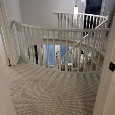 Gladiator carpet installed in upstairs hallway around spindles in London – durable and stylish carpet for high-traffic areas.