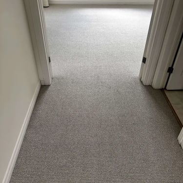 Grey Berber carpet installed in a London hallway – durable and textured carpet for high-traffic areas.