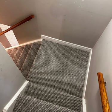 Dark grey berber carpet installed wall-to-wall on residential stairs in Tillsonburg Ontario, durable and textured flooring