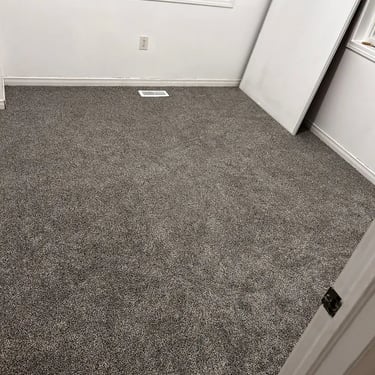 Bedroom with low pile brown plush carpet installed wall-to-wall in Southcrest London Ontario home