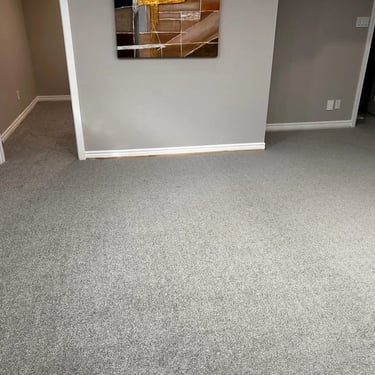 Grey plush carpet installed in a cozy basement by Master Carpet, enhancing comfort and warmth in London, Ontario homes