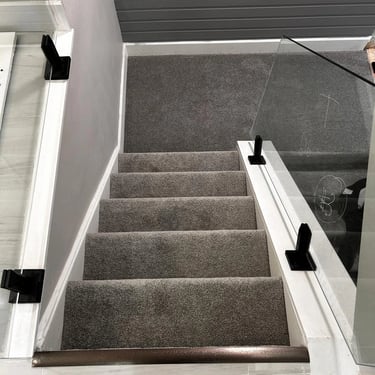 Close-up of medium pile grey plush carpet installed on basement stairs in London Ontario residential home