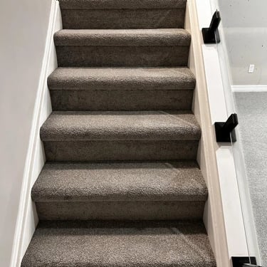 Grey plush carpet installed on basement stairs in London Ontario residential home, soft and durable flooring