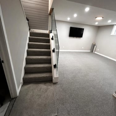 Medium pile grey plush carpet installed wall-to-wall in basement and basement stairs in London Ontario home