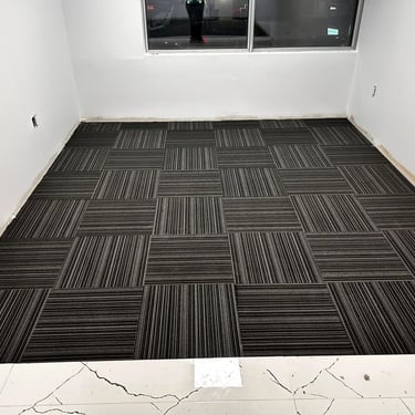 Office room with black commercial carpet tile, line design, quarter-turn install in Downtown London ON