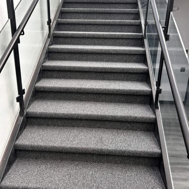 Close-up angle of Academy commercial carpet installed on concrete stairs in London Ontario, durable and slip-resistant floor.