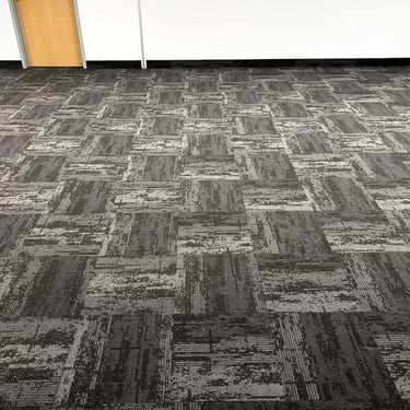 Office room with dark grey carpet tile flooring, commercial-grade installation in Byron, London Ontario