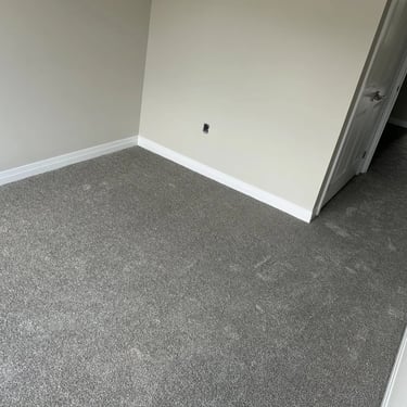 Bedroom with grey plush carpet installed wall-to-wall in Alymer Ontario residential home, soft and comfortable flooring