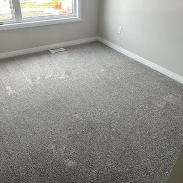 Bedroom with grey plush carpet installed wall-to-wall in Alymer Ontario residential home, soft and cozy flooring
