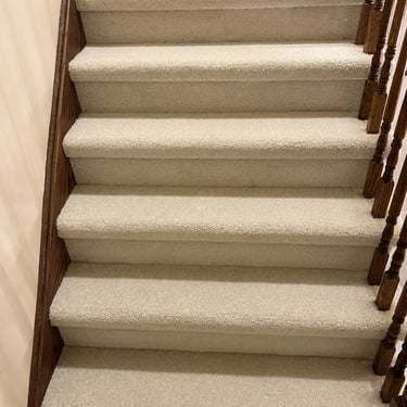 Close-up angle of Selkirk carpet installed wall-to-wall on residential stairs in Alymer Ontario home