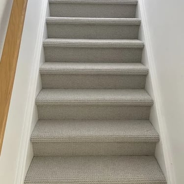 Wall-to-wall grey berber carpet installed on staircase in Masonville residential home