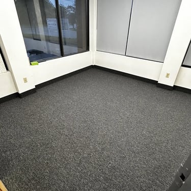 Office room with black commercial carpet installed wall-to-wall in London Ontario, durable and professional flooring