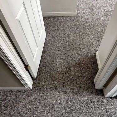 Low-pile plush grey carpet installed in hallway and bedroom in White Oaks, London – soft and durable carpet for cozy homes.