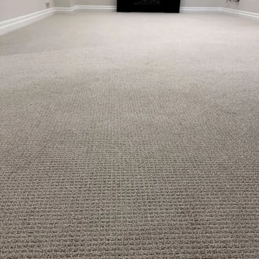 Grey Margo Berber carpet installed in a basement in London – durable and looped carpet for comfortable living spaces.