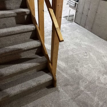 "Melford 102 low pile carpet installed on basement staircase with landing in London"