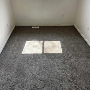 Melford grey carpet installed in London bedroom – smooth low pile design for a cozy and clean finish.