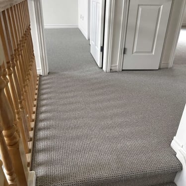 Naples Berber carpet installed in a hall next to spindles – durable textured flooring