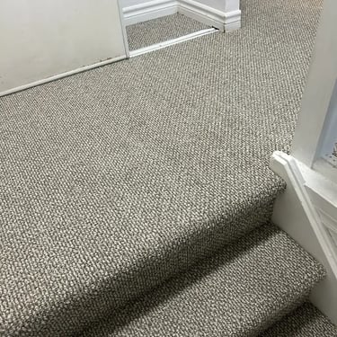 Neutral Berber carpet professionally installed on residential stairs in London, Ontario by Master Carpet