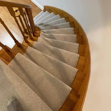 Pinpoint design carpet runner installed on staircase, featuring a subtle dotted pattern in neutral tones, bordered by wood st