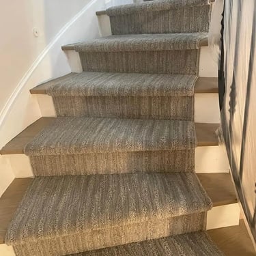 Another view of the wavy design carpet runner on stairs, showing clean edge finishing and elegant pattern flow