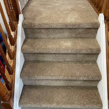 Brown thick carpet installed wall-to-wall on residential stairs in London Ontario, soft and durable flooring