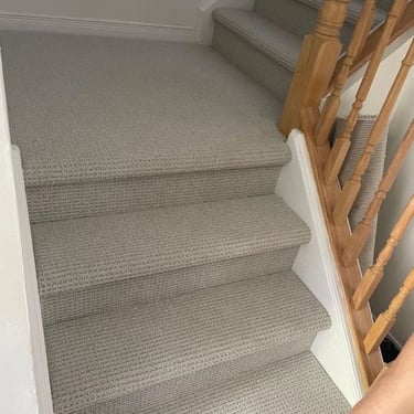 Grey berber carpet installed on staircase in Oakridge, London. Durable and textured wall-to-wall carpet for high-traffic area