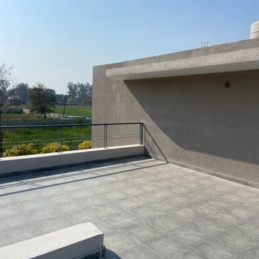 Photograph of a farmhouse under construction, designed by NexArch Studio. View of the terrace.