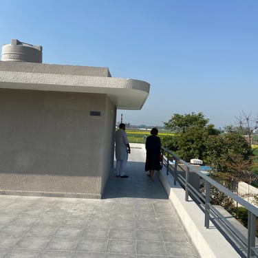 Photograph of a farmhouse under construction, designed by NexArch Studio. View of the terrace.