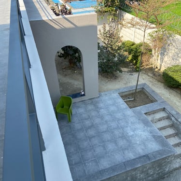 Photograph of a farmhouse under construction, designed by NexArch Studio. View of the pool side.