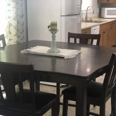 Modern kitchen with dining table and appliances at Malad Student House. Move-in ready off-campus housing in Boise, Idaho.