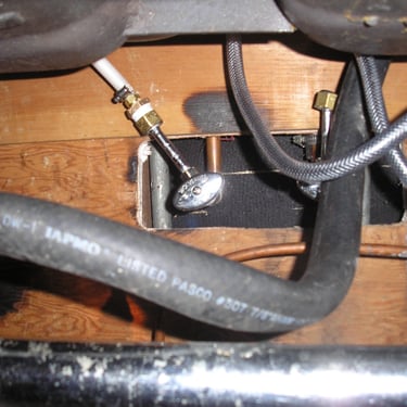 Underneath sink checking for leaks. Building maintenance.