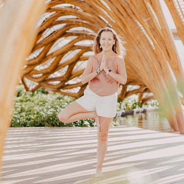 a woman in a yoga pose in Akumal Mexico