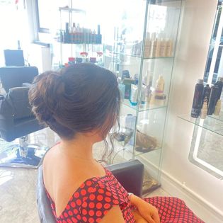 a woman sitting in a chair in  Hair salon