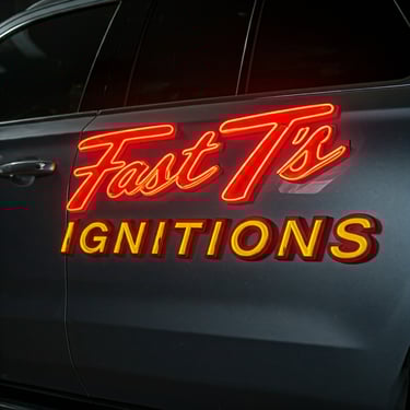 neon sign on the side of a car that says Fast T's  Ignitions 