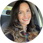 a woman in a car with a cell phone in her hand
